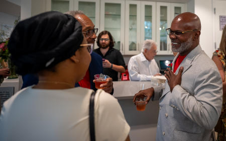 Earl Truvia talking to a guest