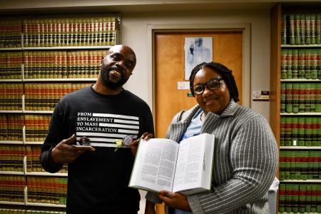 Robert and Kendra Jones with a law book from the library with Robert's case.